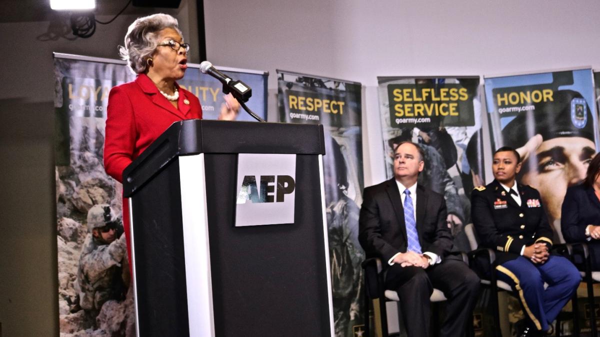 Congresswoman Beatty speaks before soldiers in uniform.