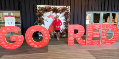 Rep. Beatty surrounded by 'Go Red' signage