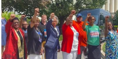 Image of Congresswoman Beatty and Black Women Leaders & Allies giving power fist.