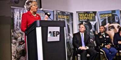 Congresswoman Beatty speaks before soldiers in uniform.