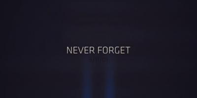 Two lights going up with words "Never Forget, September 11, 2001' in text overlay.
