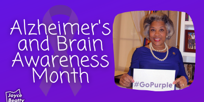 Purple background with Alzheimer's awareness purple ribbon on left and photo of Congresswoman Beatty on right holding sign that reads, "Go Purple." Text overlay on left side ribbon reads, "Alzheimer's and Brain Awareness Month."