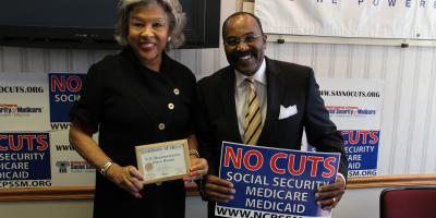 Congresswoman Beatty hold sign that reads, "No Cuts to Social Security. No Cuts to Medicare. No Cuts to Medicaid."